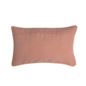 A rectangular lumbar throw pillow in a dusty rose pink color