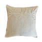 A square beige throw pillow with a textured linen-like fabric and embroidered palm tree motifs on the front