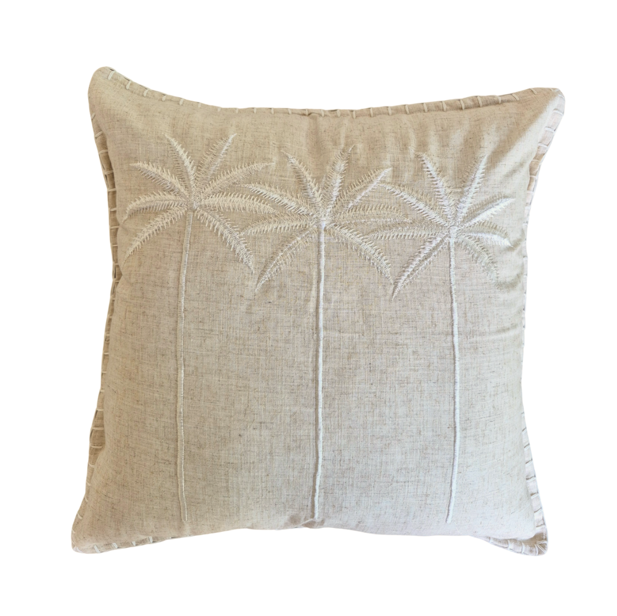 A square beige throw pillow with a textured linen-like fabric and embroidered palm tree motifs on the front