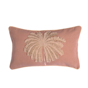 A dusty pink rectangular lumbar pillow featuring a large, raised beige palm leaf motif in the center